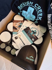 a box with a hat, a t-shirt, and other items